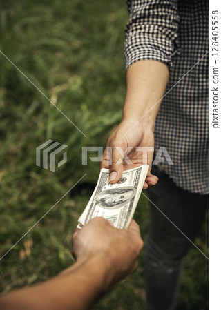 Close up hands giving money bribe payment. Hands holding dollar bill bribery financial economy business people. Business people corrupt illegal settlements try to pay graft. Corruption bribe concept Close up hands giving money bribe payment. Hands holding dollar bill bribery financial economy business people. Business people corrupt illegal settlements try to pay graft. Corruption bribe concept 128405558