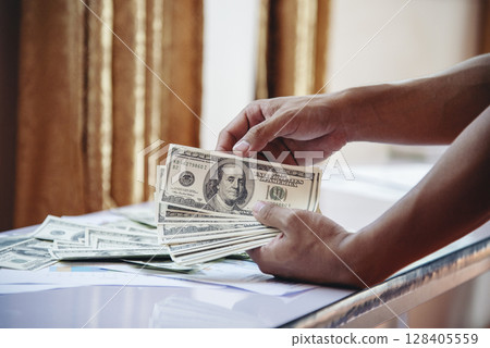 Hand holding loan money dollar bank note give financial payment. Man hands showing spread 100 dollar exchange cash payout. Saving Businessman counting money banknote bribe corruption concept. Hand holding loan money dollar bank note give financial payment. Man hands showing spread 100 dollar exchange cash payout. Saving Businessman counting money banknote bribe corruption concept. 128405559