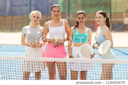 Women standing near the net on the court 128405679