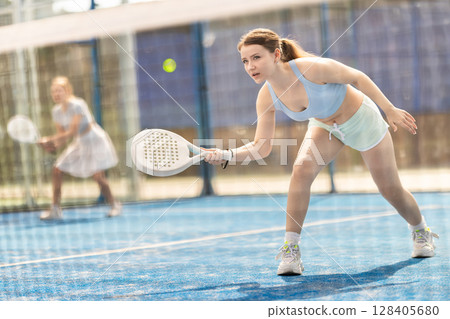 woman hits balls near the net 128405680