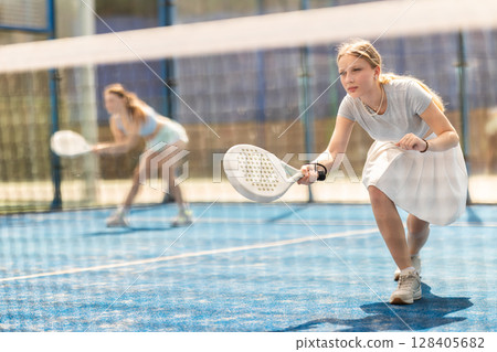 woman hits balls near the net 128405682