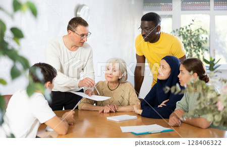 Men and women different ages discussion during business course in classroom Men and women different ages discussion during business course in classroom 128406322