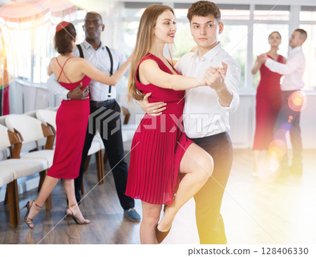 Young guy and young woman dancing tango 128406330