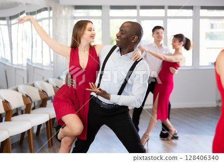 Adult man and young woman dancing tango 128406340