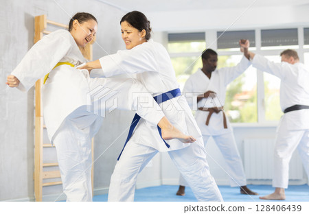 Adult and young women training judo techniques Adult and young women training judo techniques 128406439