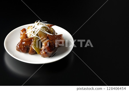 Sweet and sour pork with black vinegar photographed on a black background Sweet and sour pork with black vinegar photographed on a black background 128406454