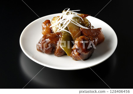 Sweet and sour pork with black vinegar photographed on a black background Sweet and sour pork with black vinegar photographed on a black background 128406456