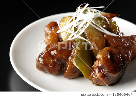 Sweet and sour pork with black vinegar photographed on a black background 128406464