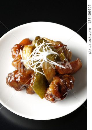 Sweet and sour pork with black vinegar photographed on a black background Sweet and sour pork with black vinegar photographed on a black background 128406495