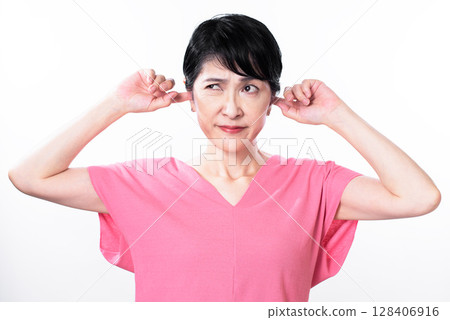 A middle-aged woman wearing a pink summer knit cap covering her ears A middle-aged woman wearing a pink summer knit cap covering her ears 128406916