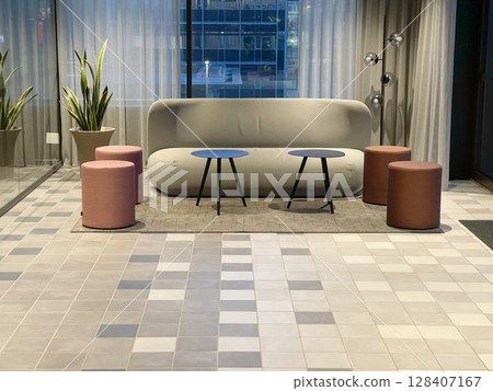 Lounge area in room by window with curtains. Soft sofa and coffee table. Modern furniture. Design in interior. Lounge area in room by window with curtains. Soft sofa and coffee table. Modern furniture. Design in interior. 128407167