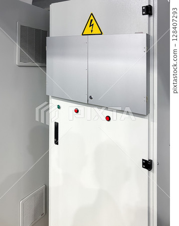 Industrial electrical panel with safety warning sign. 128407293