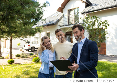 Real state agent talking to the clients after a successful deal Real state agent talking to the clients after a successful deal 128407497