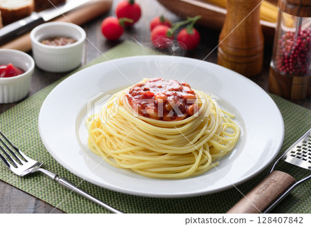 Steaming chili con carne pasta and a colorful Western-style table Steaming chili con carne pasta and a colorful Western-style table 128407842