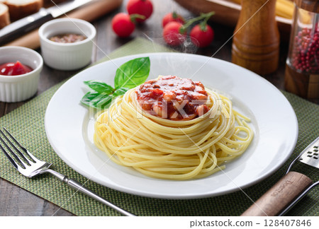 Steaming chili con carne pasta and a colorful Western-style table Steaming chili con carne pasta and a colorful Western-style table 128407846