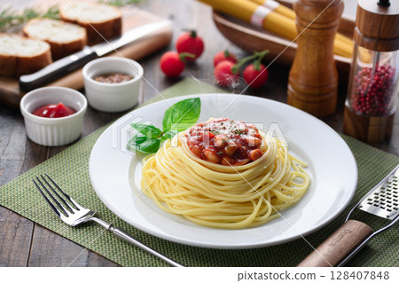 Steaming chili con carne pasta and a colorful Western-style table Steaming chili con carne pasta and a colorful Western-style table 128407848