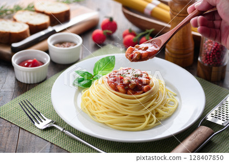 Steaming chili con carne pasta and a colorful Western-style table 128407850