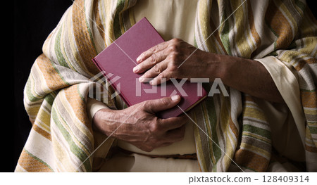 Old man holding a book Old man holding a book 128409314