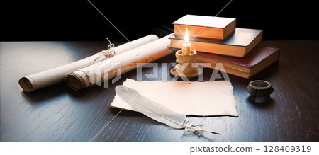 Books and candle on the table 128409319