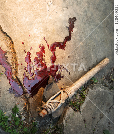 Stone axe with red blood 128409333