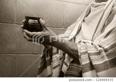 Old cup in the hands Old cup in the hands 128409335