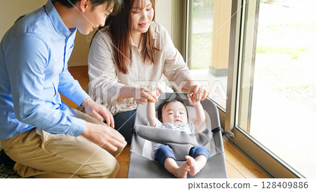 Couple soothing a baby in a room Couple soothing a baby in a room 128409886