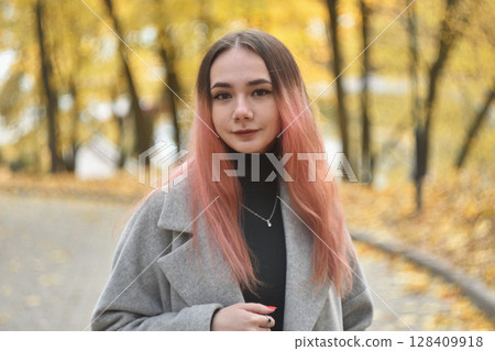 Autumn Portrait: Young woman with ombre pink hair in Golden Park Autumn Portrait: Young woman with ombre pink hair in Golden Park 128409918