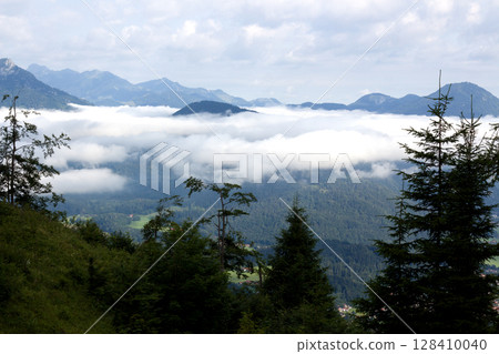 Majestic clouds blanket the valleys of Tyrol, Austria during a serene mountain morning Majestic clouds blanket the valleys of Tyrol, Austria during a serene mountain morning 128410040