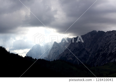 Majestic mountain range in Tyrol, Austria, under dramatic skies with cloudy weather creating a unique atmosphere 128410041