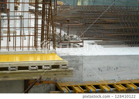 Steel Rebars and Concrete Structure on Construction Site Steel Rebars and Concrete Structure on Construction Site 128410122