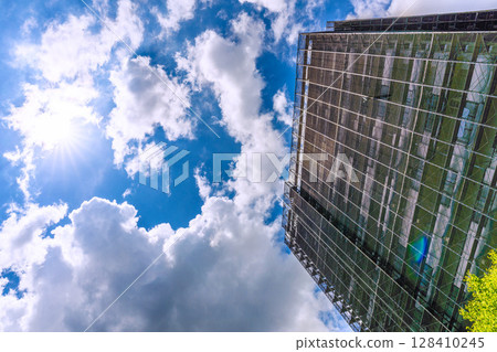 Yokohama cityscape in Japan. Apartment building repairs and inspections, scaffolding and protective nets. Satellite antennas outside the nets. 128410245