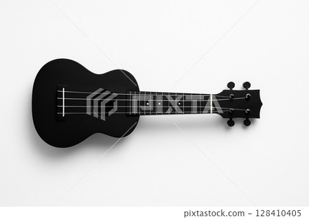 A simple black ukulele on a white background 128410405