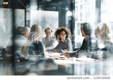 Group of Professionals Engage in Lively Discussion During Meeting in Modern Office Setting 128410800