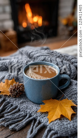 Embrace the autumn atmosphere with a burning fireplace and a hot cup of coffee, creating a warm and inviting space for relaxation 128411405