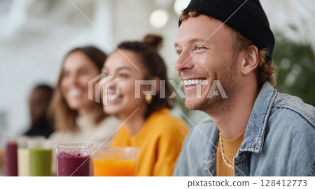Friends enjoying colorful smoothies. Happy, healthy lifestyle concept. Perfect for nutrition, wellness, or social connection themes in ads and articles. 128412773