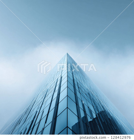 Abstract architectural shot of a glass skyscraper disappearing into the clouds. Minimalist, cool tones. Evokes ambition, aspiration, and corporate success. 128412976