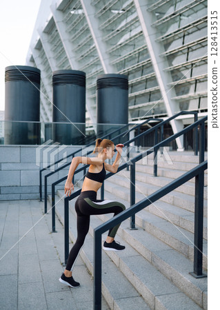 Slim woman doing exercises outdoors in the morning. Active life, sports training, healthy lifestyle. Slim woman doing exercises outdoors in the morning. Active life, sports training, healthy lifestyle. 128413515