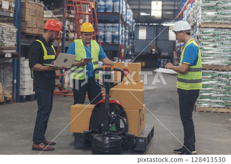 Warehouse worker teamwork diversity men using laptop computer logistics checking products in store inventory. Warehouse management team partner engineer man work together checklist stock control 128413530