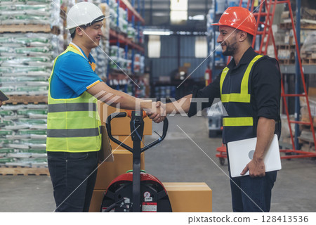 Teamwork Warehouse worker shakehand together. Engineer man hands partnership. Diversity Coworker Men logistics Warehouse teams handshake. Multiracial Support team greeting person teamwork colleagues 128413536
