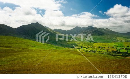 Soft light bathes the verdant hills and mountains, creating a stunning contrast. A moment of peace. Soft light bathes the verdant hills and mountains, creating a stunning contrast. A moment of peace. 128413708