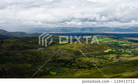 This is a picture taken from the sky of the beautiful green valleys and mountains in Coomloughra Horseshoe, Ireland. This is a picture taken from the sky of the beautiful green valleys and mountains in Coomloughra Horseshoe, Ireland. 128413711