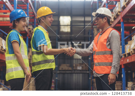 Asian Engineer man, women hands partnership. Coworker colleague logistics Warehouse teams handshake. Teamwork Warehouse worker shakehand together. Support team person teamwork partner logistics team 128413738