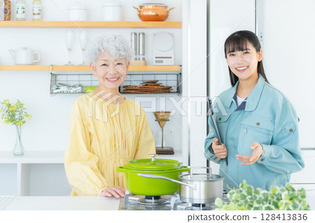 Real estate agent explaining to senior woman in kitchen Real estate agent explaining to senior woman in kitchen 128413836
