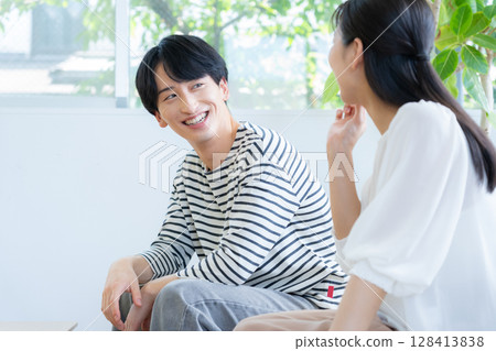 A young couple relaxing in the living room A young couple relaxing in the living room 128413838