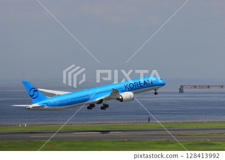 Passenger plane taking off, passenger plane ascending, Korean Air plane with new paint job Passenger plane taking off, passenger plane ascending, Korean Air plane with new paint job 128413992