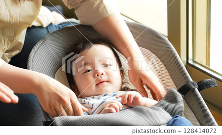 Couple soothing a baby in a room Couple soothing a baby in a room 128414072