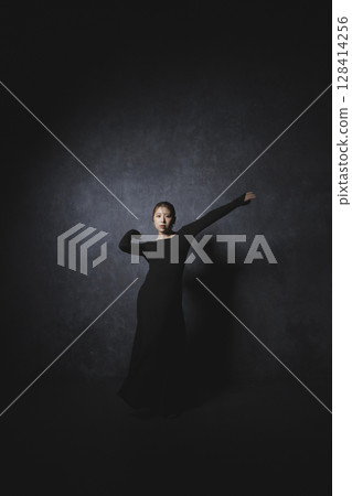 Woman posing against black background Woman posing against black background 128414256