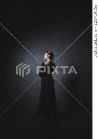 Woman posing against black background Woman posing against black background 128414258
