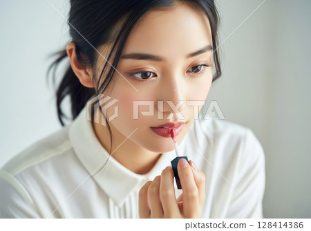 一位日本女性將頭髮綁在腦後，塗上別緻的唇彩 128414386