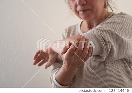 Elderly European Woman Suffering from Joint Pain, for Example in the Elbow Elderly European Woman Suffering from Joint Pain, for Example in the Elbow 128414446